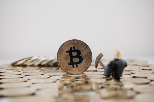 Cryptocurrency physical gold bitcoin coin near miner on the gold.