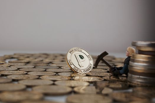 Cryptocurrency physical gold peercoin coin near miner and big money.