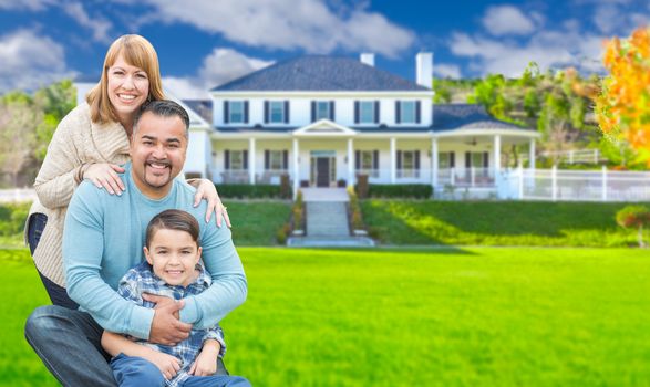 Mixed Race Family In Front Yard of Beautiful House and Property.