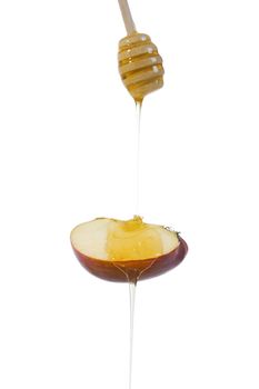 Honey flows down on a piece of apple on a white background