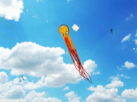 Big kite flying in a blue sky. Kites of various shapes. kiting
