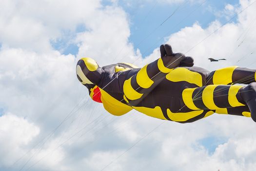 kites flying in a blue sky. Kites of various shapes. kiting