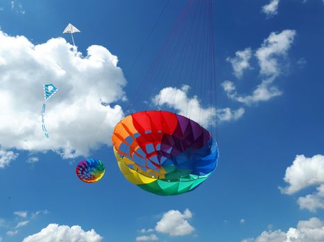 kites flying in a blue sky. Kites of various shapes. kiting