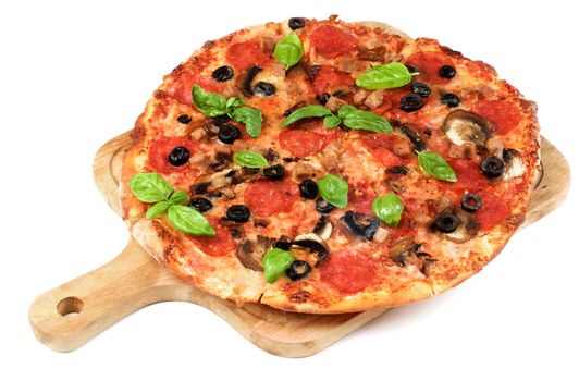 Homemade Pepperoni Pizza with Mushrooms, Black Olives, Ham and Basil on Wooden Cutting Board closeup on White background