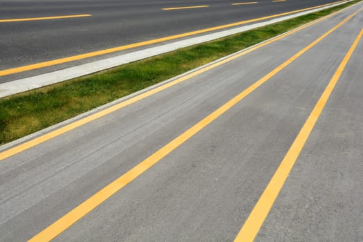 Detail of a road with yellow lines