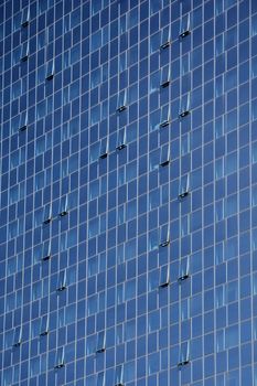 Detail of a glass building front with blue windows