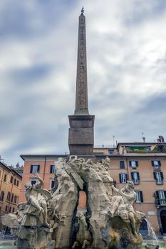 the famous Fontana dei quattro fium (four rivers fountain) in Piazza Navona, Rome, Italy. outdoor shot, cloudy weather