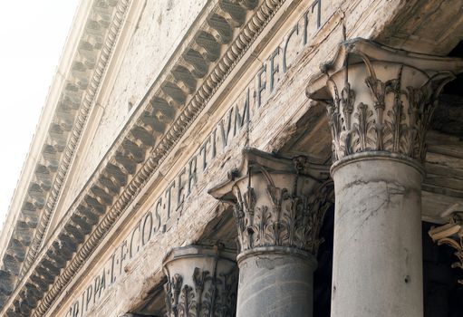 close up of the Pantheon pediment with latin inscription, corinthian capital columns, Rome, Italy