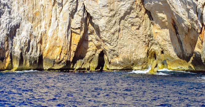 clear blue water sea with rocky coastline in Italy