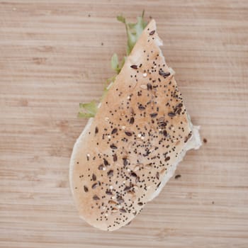 Tasty sandwich white bread on the wooden board in the kitchen.