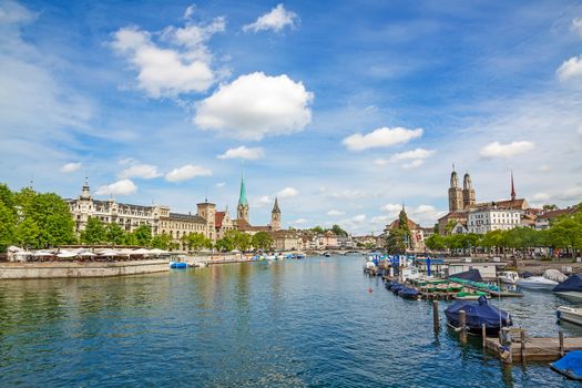 Panoramic view of downtown Zurich city center with famous Grossmuenster, Fraumuenster, St. Peter church and river Limmat at Lake Zurich (Switzerland) on a sunny day with clouds in summer