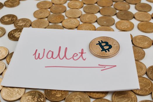 Digital currency physical gold bitcoin coin on paper with wallet red arrow.