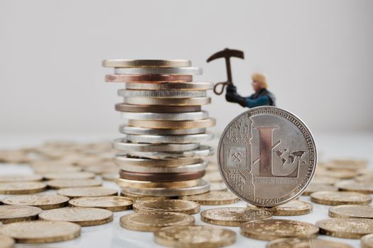 Digital currency physical silver Litecoin coin on the money near miner.