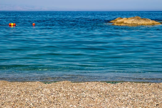 Sand the rocks and a blue Mediterranean sea