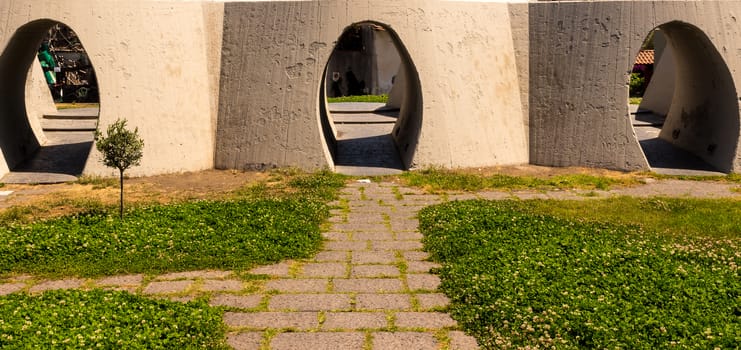 The three holes in a city park with a green grass