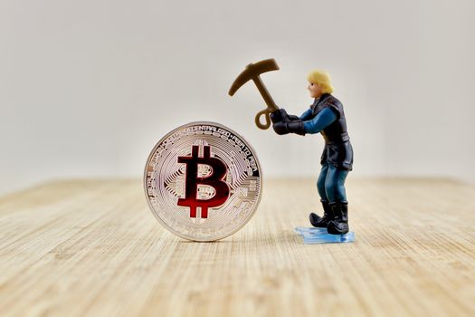 Digital currency physical silver bitcoin coin near miner.