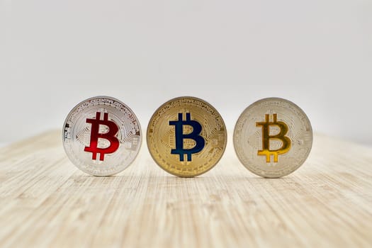 Digital currency physical gold and silver bitcoin coins on the wooden board.
