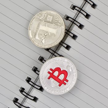 Digital currency physical silver Litecoin and Red Bitcoin coin.