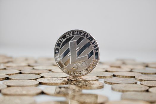 Digital currency physical silver Litecoin coin on gold coins.