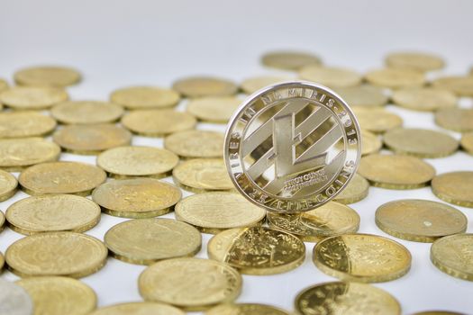 Cryptocurrency physical silver Litecoin coin on the gold money.