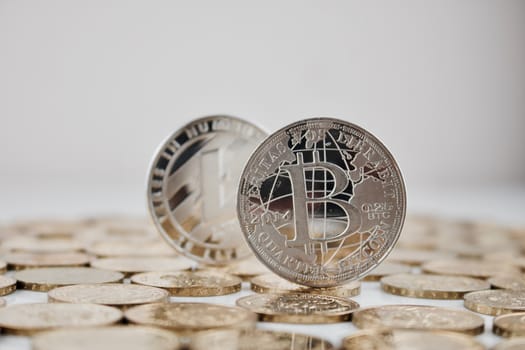 Digital currency physical silver bitcoin coin and silver Litecoin coin.