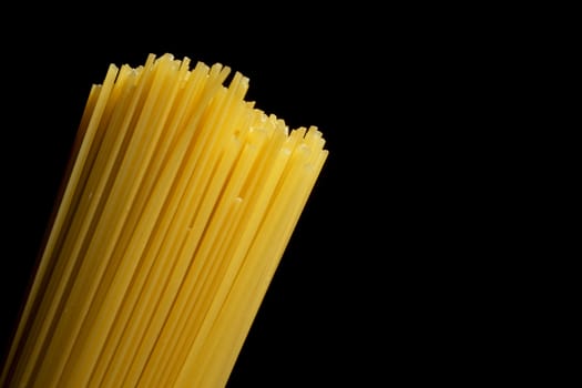 Beam of Italian pasta on a black background