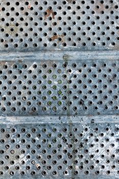 Abstract background texture of old metal in hole close-up