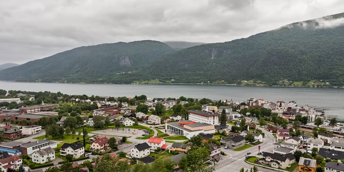 Panoramic view of Andalsnes city in Norway with mountains on background under a cloudy sky