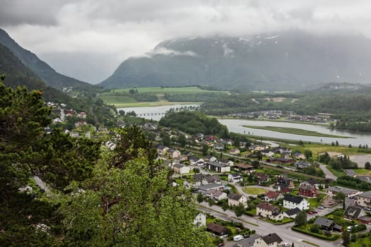 View of Andalsnes city in Norway with mountains on background under a cloudy sky