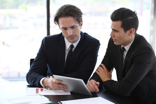 Business people using tablet pc together at office