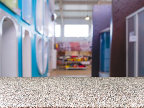 Marble empty table in front of blurred DIY supermarket background. Mock up for display of product.