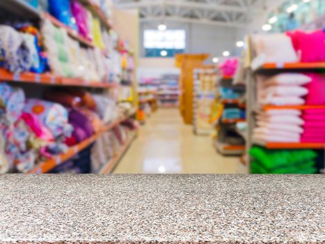 Marble empty table in front of blurred DIY supermarket background. Mock up for display of product.