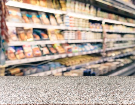 Marble board empty table in front of blurred supermarket - can be used for display or montage your products. Mockup for display of product.