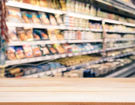 Light wooden board empty table in front of blurred background. Perspective light wood over blur in supermarket - can be used for display or montage your products. Mockup for display of product.