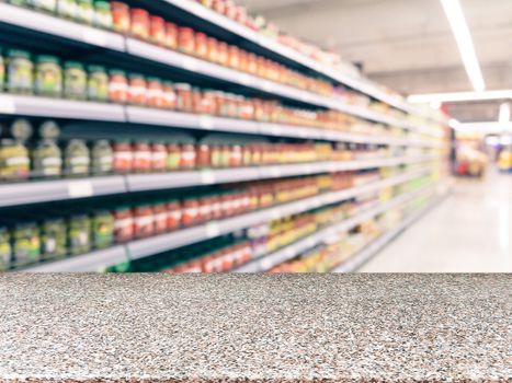 Marble board empty table in front of blurred supermarket - can be used for display or montage your products. Mockup for display of product.