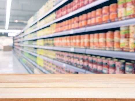 Light wooden board empty table in front of blurred background. Perspective light wood over blur in supermarket - can be used for display or montage your products. Mockup for display of product.