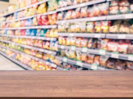 Brown wooden board empty table in front of blurred background. Perspective dark wood over blur in supermarket - can be used for display or montage your products. Mockup for display of product.