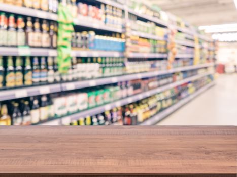 Brown wooden board empty table in front of blurred background. Perspective dark wood over blur in supermarket - can be used for display or montage your products. Mockup for display of product.