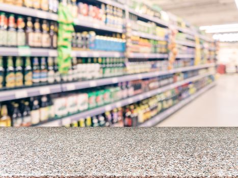 Marble board empty table in front of blurred supermarket - can be used for display or montage your products. Mockup for display of product.