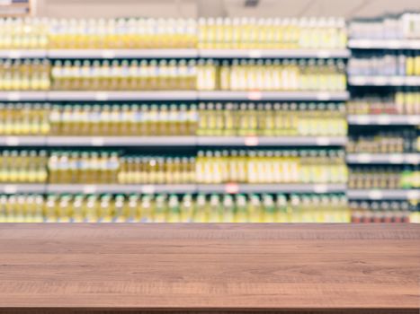 Brown wooden board empty table in front of blurred background. Perspective dark wood over blur in supermarket - can be used for display or montage your products. Mockup for display of product.