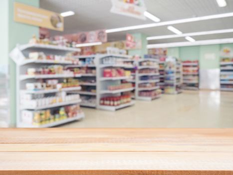 Light wooden board empty table in front of blurred background. Perspective light wood over blur in supermarket - can be used for display or montage your products. Mockup for display of product.