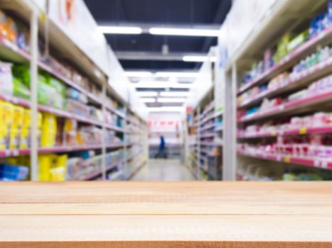 Light wooden board empty table in front of blurred background. Perspective light wood over blur in supermarket - can be used for display or montage your products. Mockup for display of product.