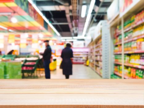 Light wooden board empty table in front of blurred background. Perspective light wood over blur in supermarket - can be used for display or montage your products. Mockup for display of product.