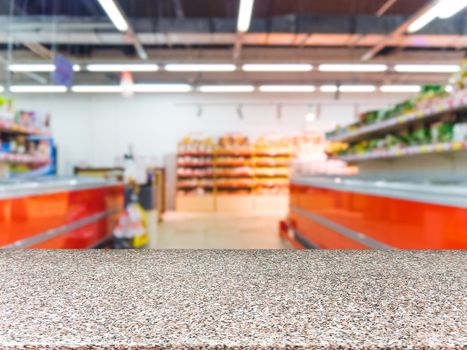 Marble board empty table in front of blurred supermarket - can be used for display or montage your products. Mockup for display of product.