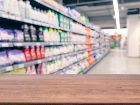 Brown wooden board empty table in front of blurred background. Perspective dark wood over blur in supermarket - can be used for display or montage your products. Mockup for display of product.