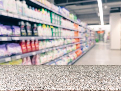 Marble board empty table in front of blurred supermarket - can be used for display or montage your products. Mockup for display of product.