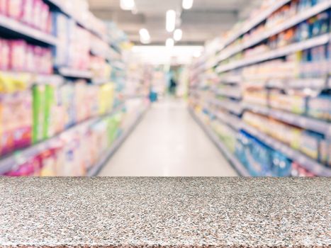 Marble board empty table in front of blurred supermarket - can be used for display or montage your products. Mockup for display of product.