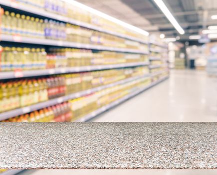 Marble board empty table in front of blurred supermarket - can be used for display or montage your products. Mockup for display of product.