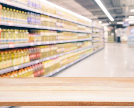 Light wooden board empty table in front of blurred background. Perspective light wood over blur in supermarket - can be used for display or montage your products. Mockup for display of product.