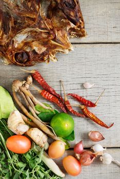 Dried fish and spices on wooden floor.